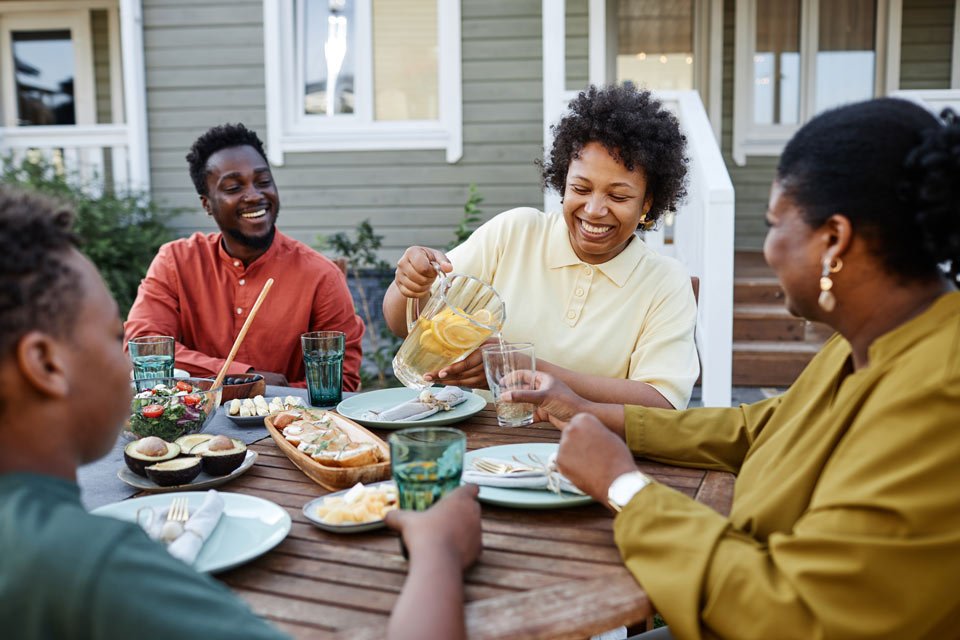 family enjoying dinner together outside