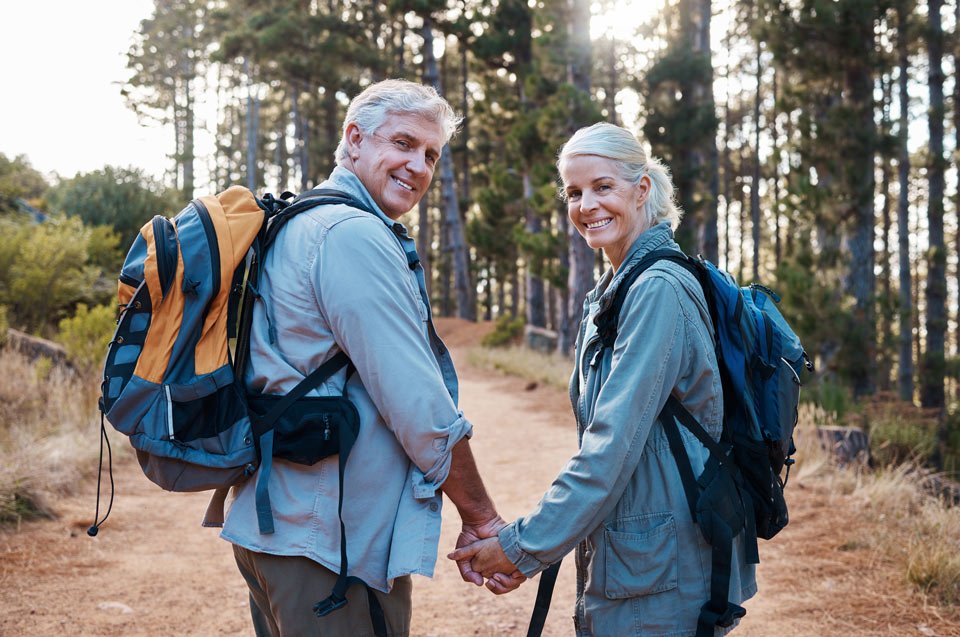 smiling man and woman hiking