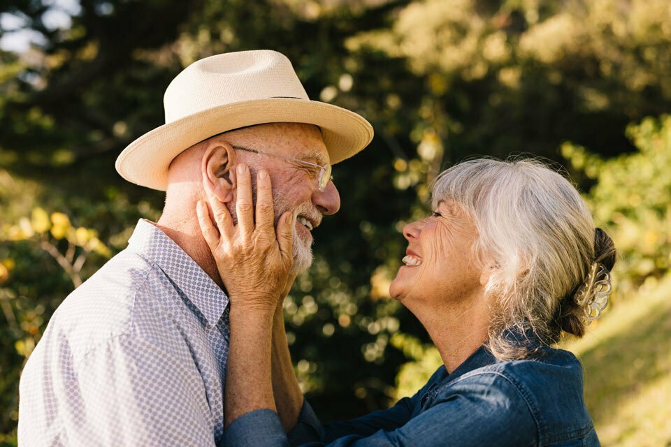 older couple laughing at each other lovingly
